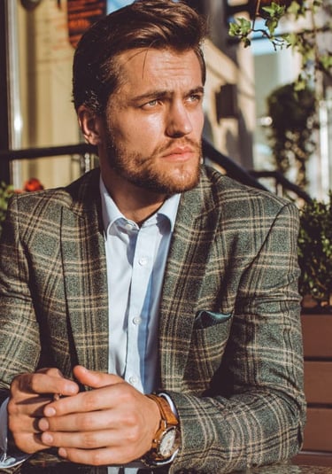 a sugar daddy in a suit and a watch
