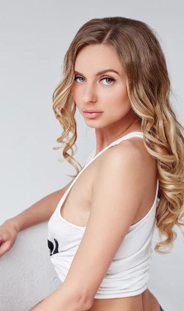 a woman in a white top and jeans shorts